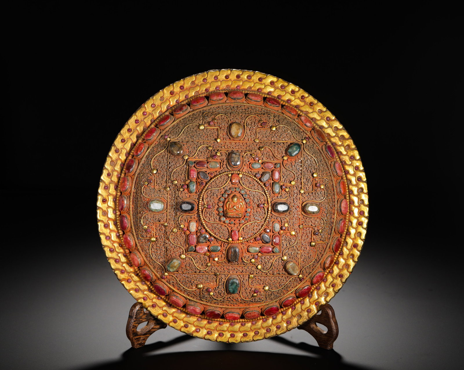 BRONZE GILDED AND INLAID MANDALA PLATE OF THE QING DYNASTY: Diameter:27.6cm (10.87in) Weight:1290g(2.84lb)Fully gilded copper mandala offering plate, Qing Tibetan Buddhism. Circular form with double-layer wavy gilded rim inlaid with rubies, sapphires, crystal 