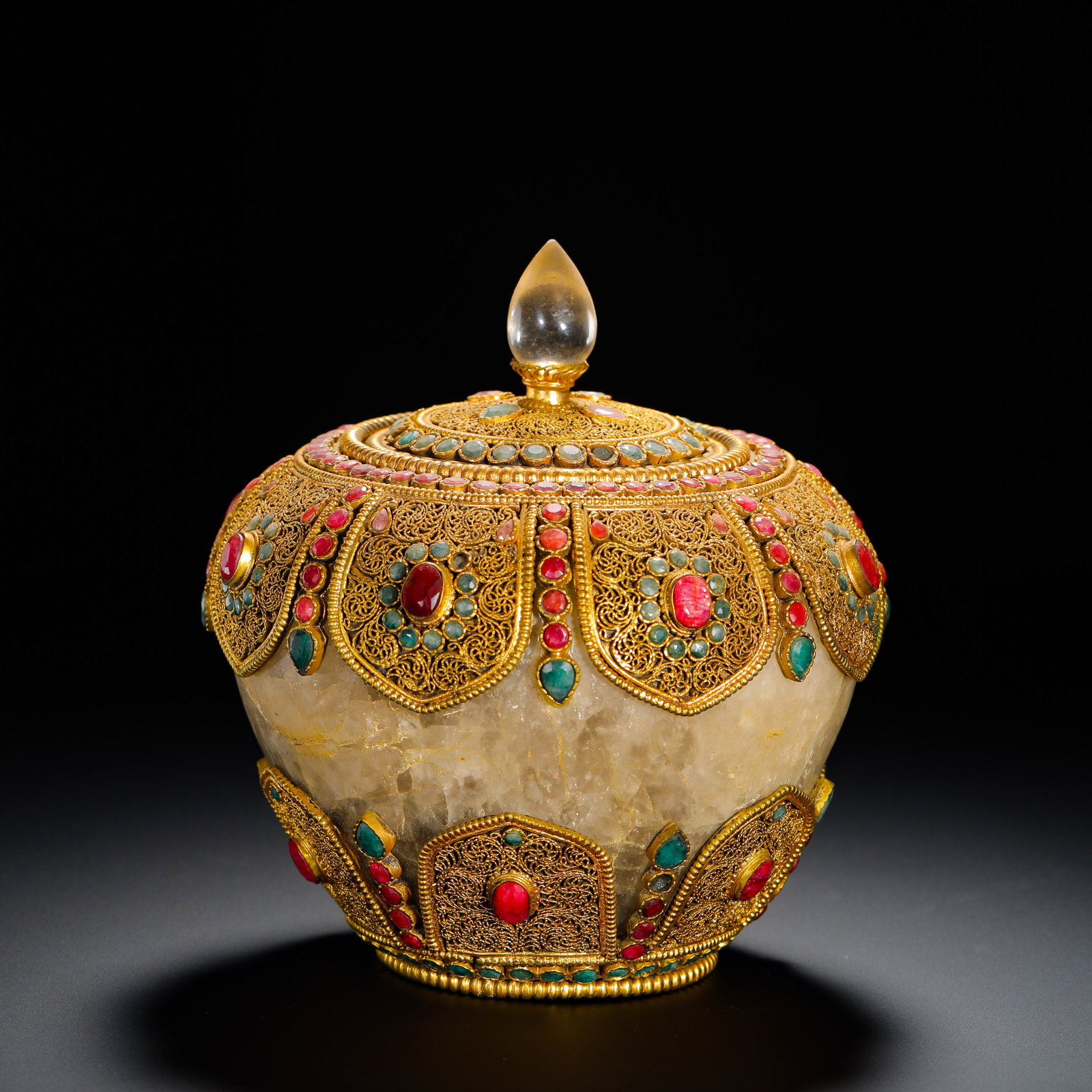 QING DYNASTY CRYSTAL FILAMENTOUS GILDED INLAID TREASURE CHUANGABALA OFFERING JAR: Height:15cm (5.91in) Width:15cm (5.91in) Weight:2280g(5.03lb)Tibetan Buddhist offering jar of crystal with filigree gilded silver inlaid gemstones, Qing Dynasty.The jar body is hollowed from a single 