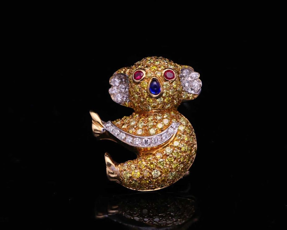ITALIAN BRAND PEDEZANI 18K GOLD GEMSTONE KOALA BROOCH: Ruby eyes, sapphire nose, yellow and blue sapphires, diamond, cute design, exquisite craftsmanship, signed Pederzani, size 25.2 x 20 mm.