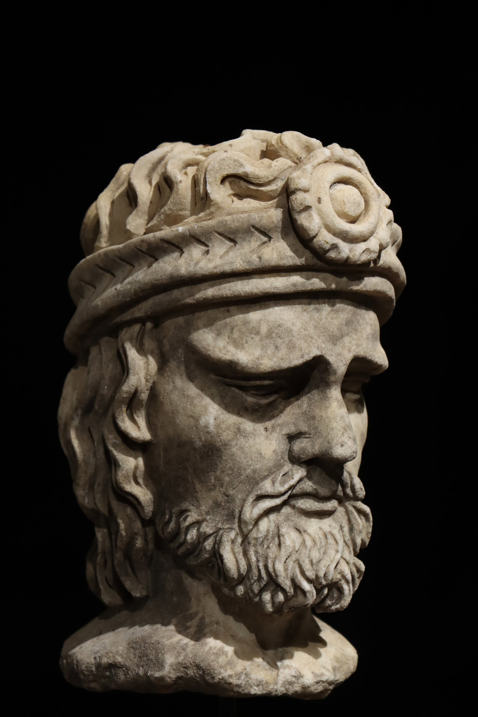 A 5TH-CENTURY ANCIENT GREEK STONE-CARVED HEAD: H:44cm H:25cmSuch heads typically represented kings or saints, often found as architectural decorations in churches, reflecting the religious faith and royal reverence of medieval Europe. This piece