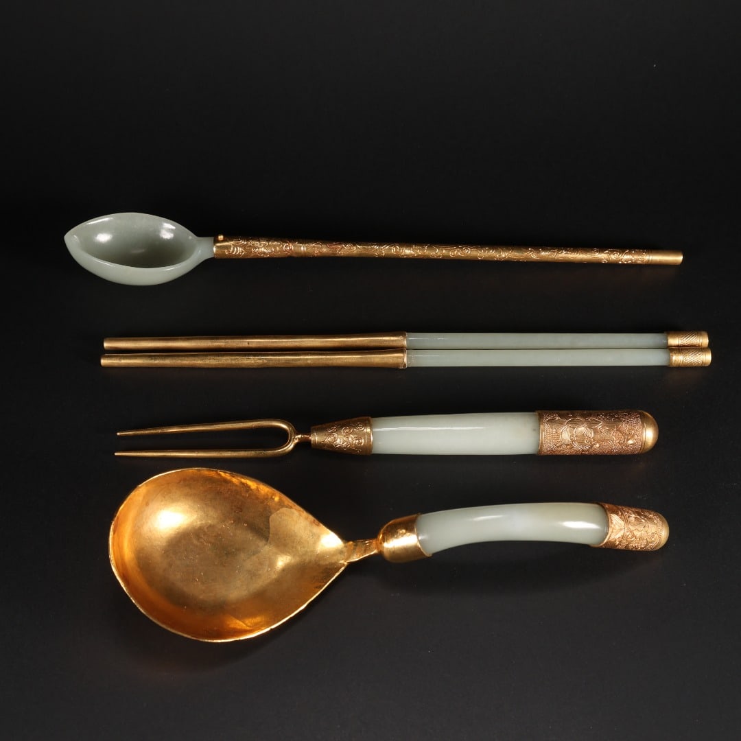 A SET OF FIVE PIECES OF HETIAN JADE BRONZE GILDED TABLEWARE FROM THE QING DYNASTY: 1.Spoon:Weight64gramsLength24.4cmWidth3.4cm.2.Fork:Weight37gramsLength8.8cm.3.Bent-handledspoon:Weight61gramsLength8cmWidth5.6cm.4.Pairofchopsticks:Weight75gramsLength22.6cm.Set of tableware made of g