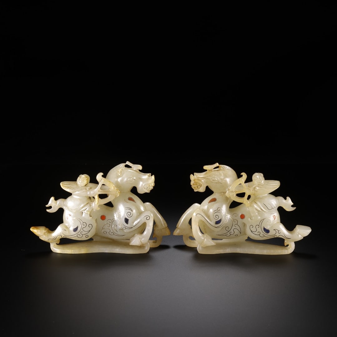 A PAIR OF HAN HETIAN JADE INLAID WITH GOLD AND SILVER INLAID WITH JEWELS ON HORSEBACK ARCHERY: Long:11.8cm(4.65in), Width:2.6cm(1.02in), Height:7.5cm(2.95in), Weight:392g (0.864lb)Pair of ancient jade ornaments: winged immortal on galloping horse with silver inlay and gemstones. Sculpted from g