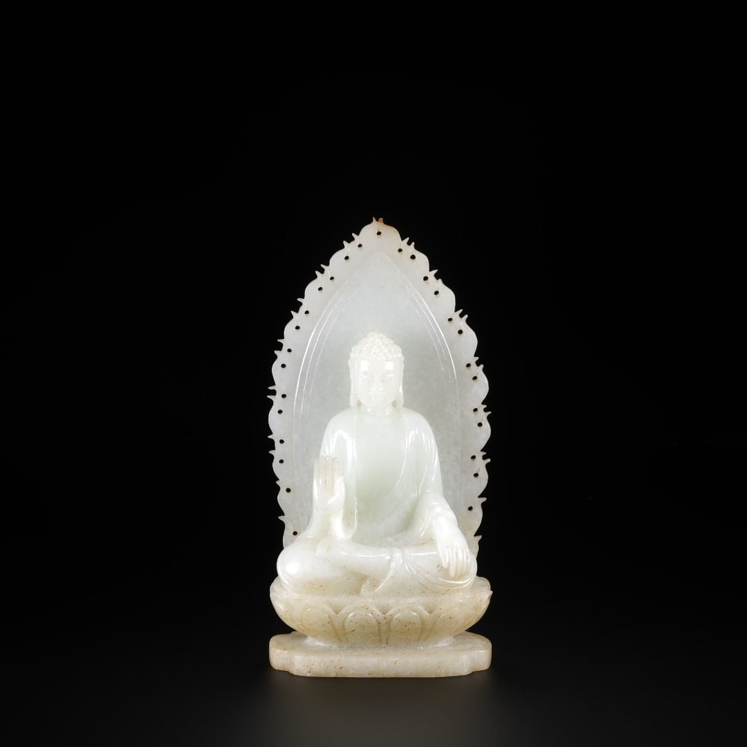 QING HETIAN JADE FLAME-BACKLIT SITTING BUDDHA: Long:6.1cm(2.40in), Width:3.2cm(1.26in), Height:12.4cm(4.88in), Weight:271g (0.597lb)Crafted from premium Hetian white jade with mild luster and natural aged inclusions. The Buddha sits in lotus posit