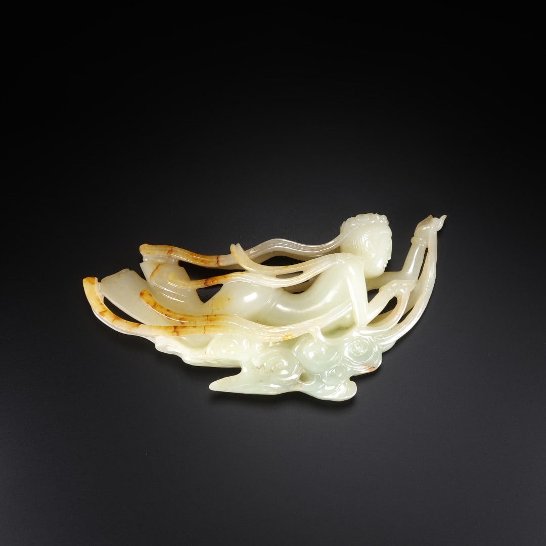 TANG DYNASTY HETIAN JADE FLYING APSARAS ORNAMENTS: Long:16.2cm(6.38in), Width:2.6cm(1.02in), Height:8.6cm(3.39in), Weight:265g (0.584lb)Crafted from Hetian white jade with mild luster and elegant natural russet inclusions. The celestial maiden flies