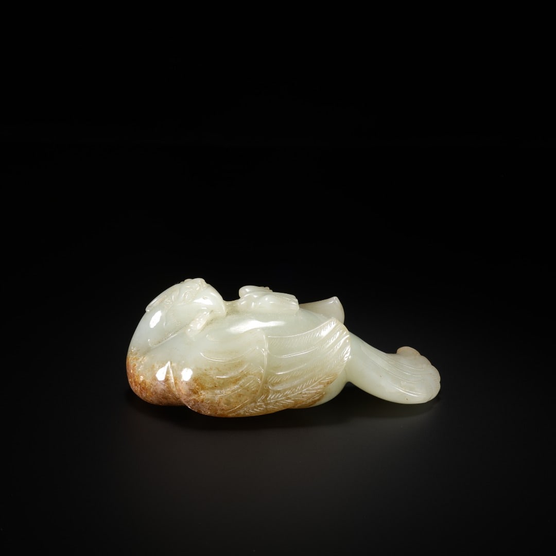 HAN HETIAN JADE PHOENIX ORNAMENT: Long:9.7cm(3.82in), Width:4.4cm(1.73in), Height:3.5cm(1.38in), Weight:188g (0.414lb)Roundly carved from mild Hetian white jade with natural brown russet at the base. The resting phoenix displays