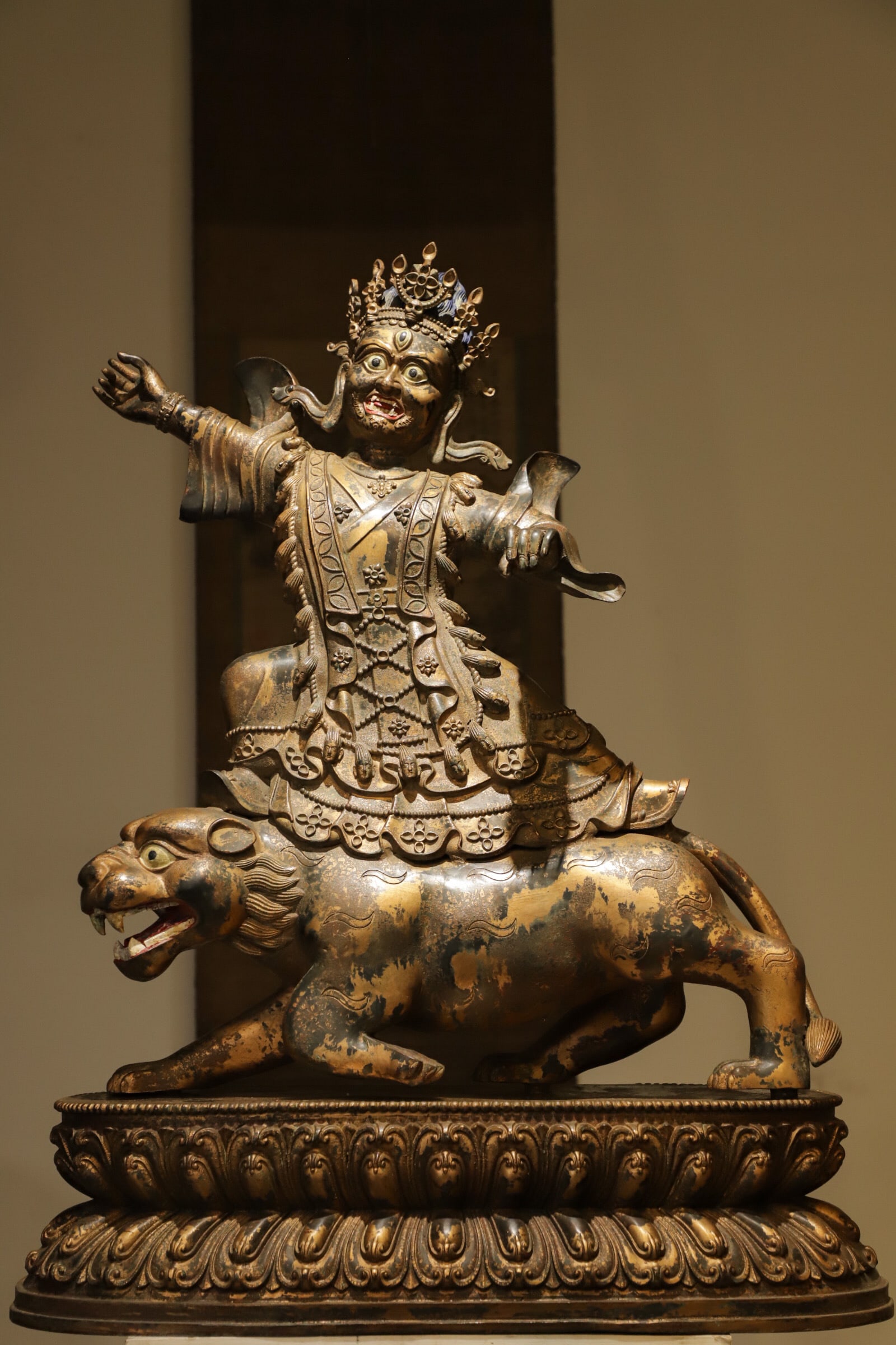 BRONZE GILDED LION-RIDING GUARDIAN DEITY FROM THE YUAN DYNASTY (1 of 9)