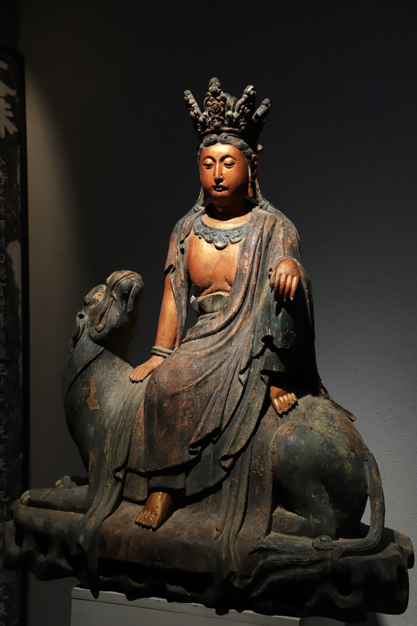 SONG DYNASTY WOODCARVING PAINTED RIDING ?? FREE AND EASY GUANYIN: Height:93cm(36.61in) Width:72cm(28.35in)Antique wooden painted Guanyin riding sacred beast, Song-Yuan period, faded mineral pigments and gilding, Buddhist statue for warding off evil and blessing