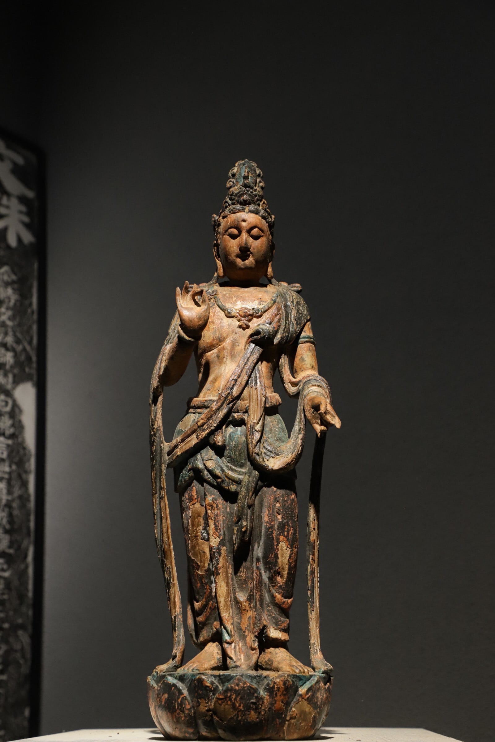 SONG DYNASTY WOODBLOCK PAINTED GUANYIN STANDING FIGURE: Height:55cm(21.65in) Width:19cm(7.48in)Antique Song-Yuan wooden painted standing Guanyin on lotus base, worn faded mineral pigments and gilding, Buddhist statue embodying mercy and blessing.