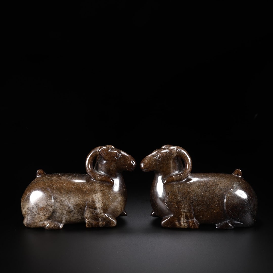 A PAIR OF HAN HETIAN JADE RECLINING SHEEP ORNAMENTS (1 of 9)