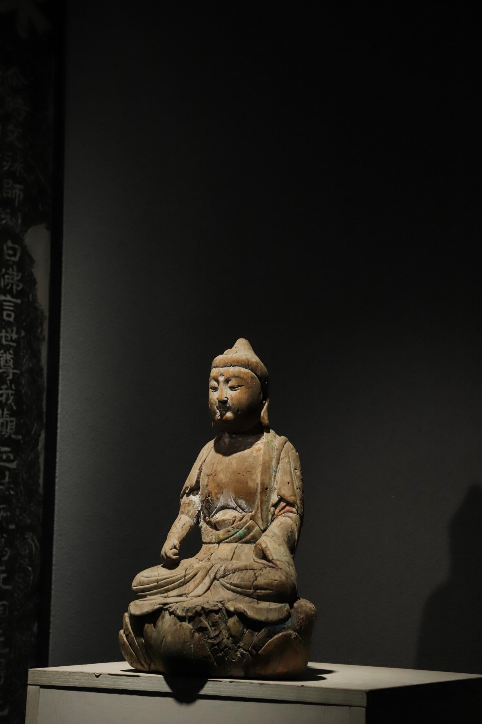 WOODEN BUDDHA STATUES FROM THE SONG DYNASTY: Height:38cm(14.96in), Long:22cm(8.66in), Width:15cm(5.91in)Carved from single wood block. The Buddha bears a tranquil face with half-closed eyes. Draped in traditional robe with flowing folds, traces 