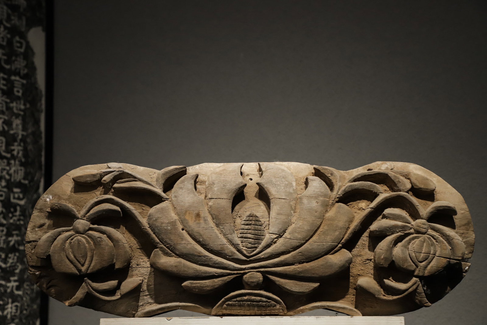 TANG DYNASTY WOOD CARVINGS: Long:60cm(23.62in), Height:21cm(8.27in), Width:13cm(5.12in)An ancient architectural wooden component crafted in high relief. A full-bloom lotus sits in the center, flanked by flower buds and winding b