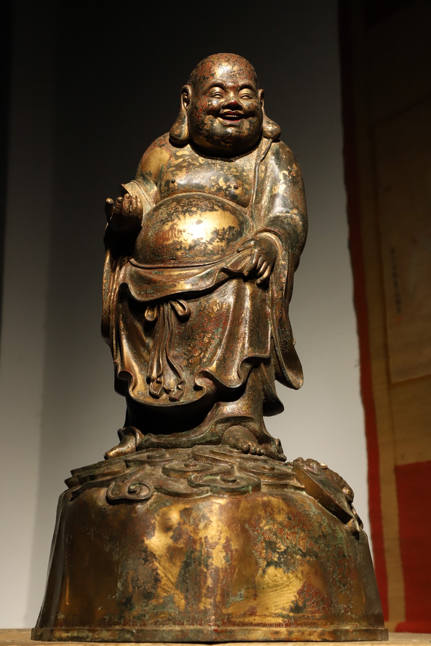 A GILDED BRONZE STANDING STATUE OF MAITREYA BUDDHA FROM THE MING DYNASTY: Weight:16800g (37.038lb), Height:65cm(25.59in), Long:33cm(12.99in), Width:28cm(11.02in)This gilt bronze standing statue of Maitreya Buddha dates to the Ming Dynasty. Crafted in gilt bronze, its gilded