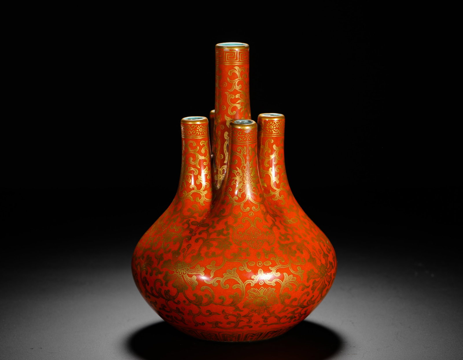 QING QIANLONG ALUM RED GILDED ENTWINED FLOWER FIVE-TUBE VASE: H:18cm (7.09in) D:14cm (5.51in) Weight:460g (1.01lb) This is an imperial porcelain vase from the Qianlong period, decorated with floral scrolls in iron-red and gold, exemplifying the luxury and crafts