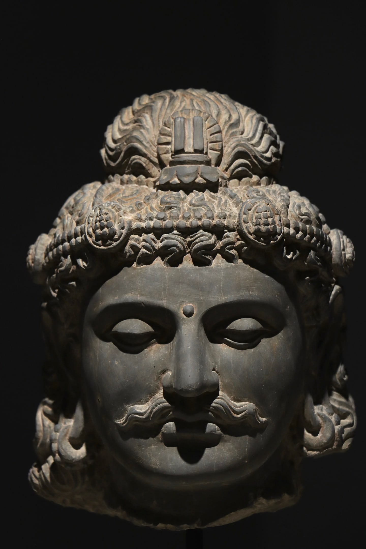 4TH CENTURY GANDHARA STATUES: Height:52cm Height:30cm Grey schist Gandhara male deity stone head, Greco-Buddhist carving, with moustache, ornate pearl diadem and sacred tri-shaft symbol