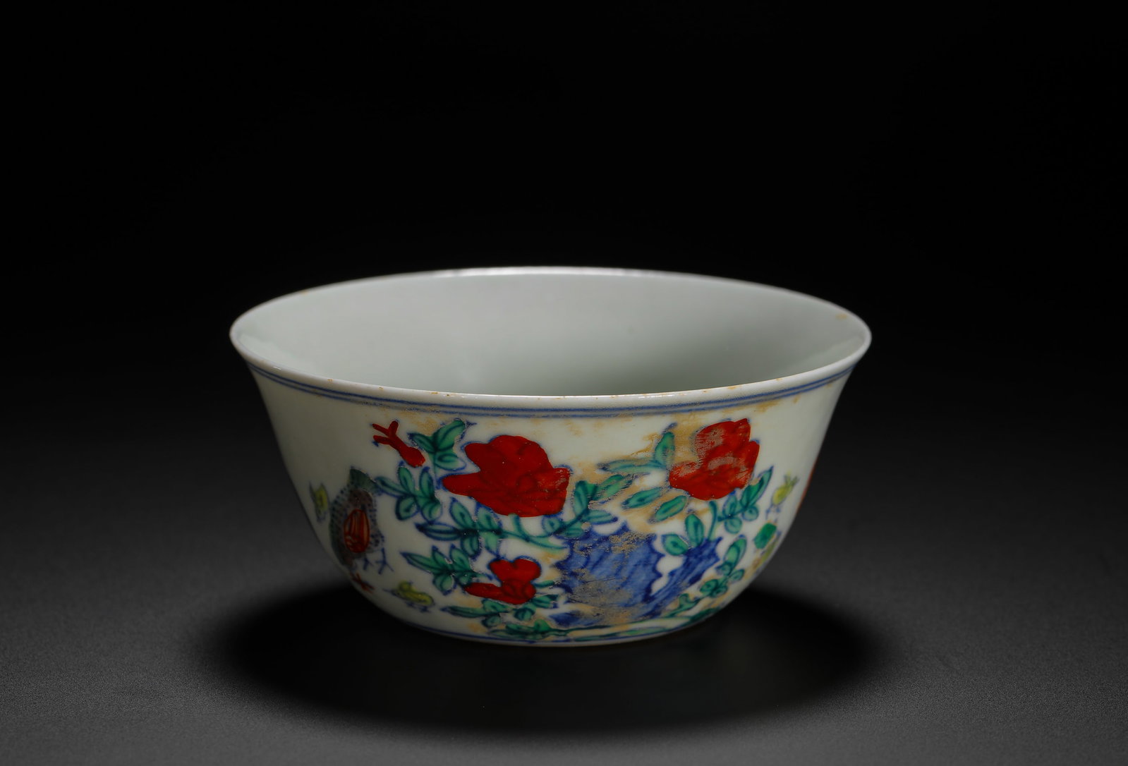 MING CHENGHUA DOUCAI CHICKEN JAR CUP: H:3.8cm (1.50in) D:8.3cm (3.27in) Weight:50g (0.11lb)This is a Chenghua period imperial porcelain cup from the Jingdezhen Kiln, decorated with chickens, rocks, and peonies in the doucai technique. Mar