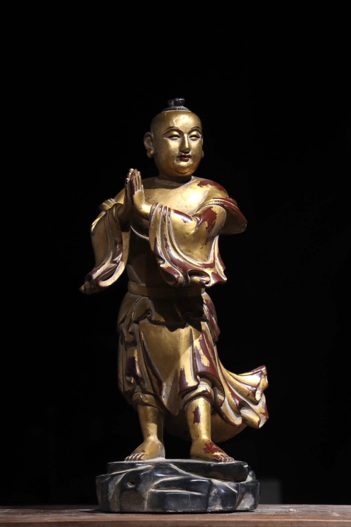 A WOODCARVING OF A GOOD FORTUNE BOY FROM THE MING DYNASTY: Height:54cm (21.26in)Wooden standing worshipping boy statue covered with gold foil, hands folded in prayer, traditional Chinese Buddhist wooden sculpture