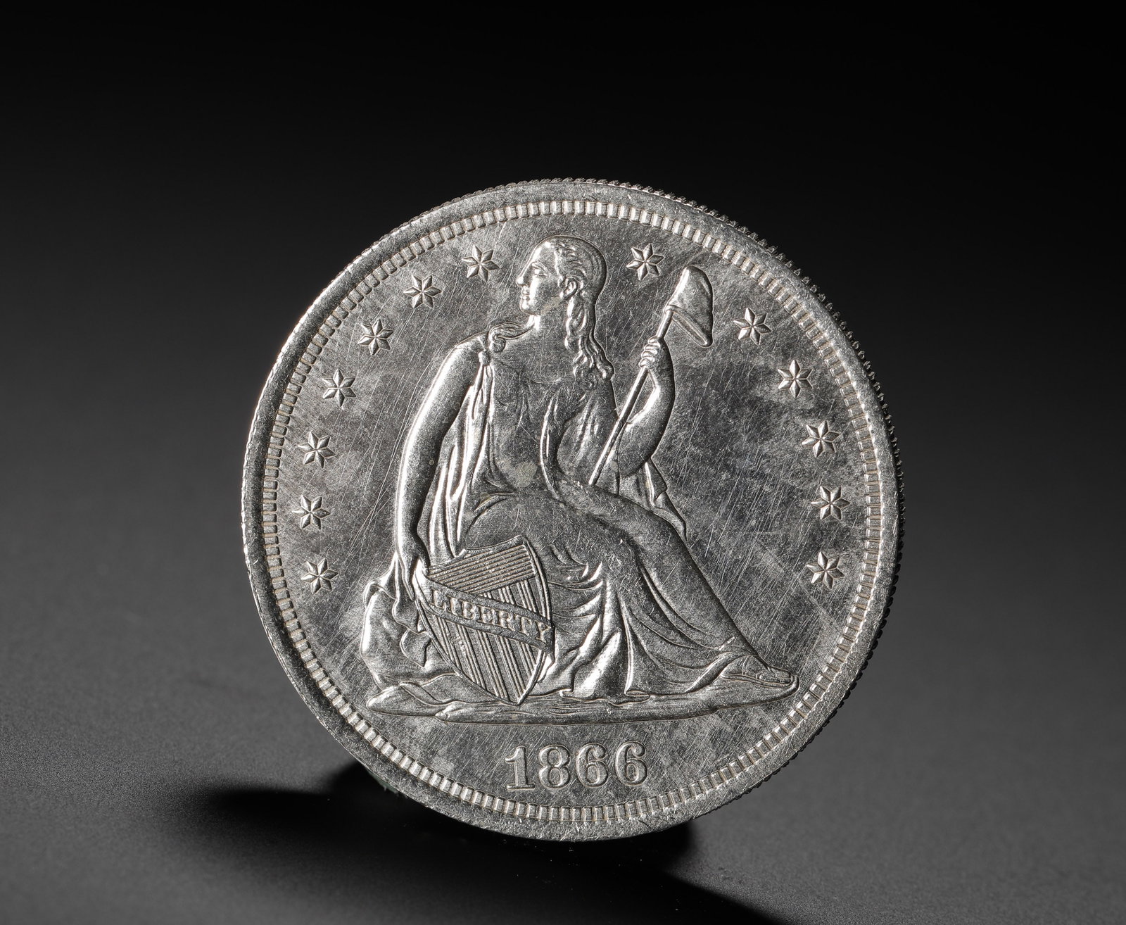 AMERICAN SEATED STATUE OF LIBERTY SILVER DOLLAR 1866: D:3.9cm (1.54in) Weight:27g (0.06lb) A key-date issue of the Seated Liberty Silver Dollar series, minted in 1866 as the first year to include the national motto "In God We Trust" on the coin, carrying