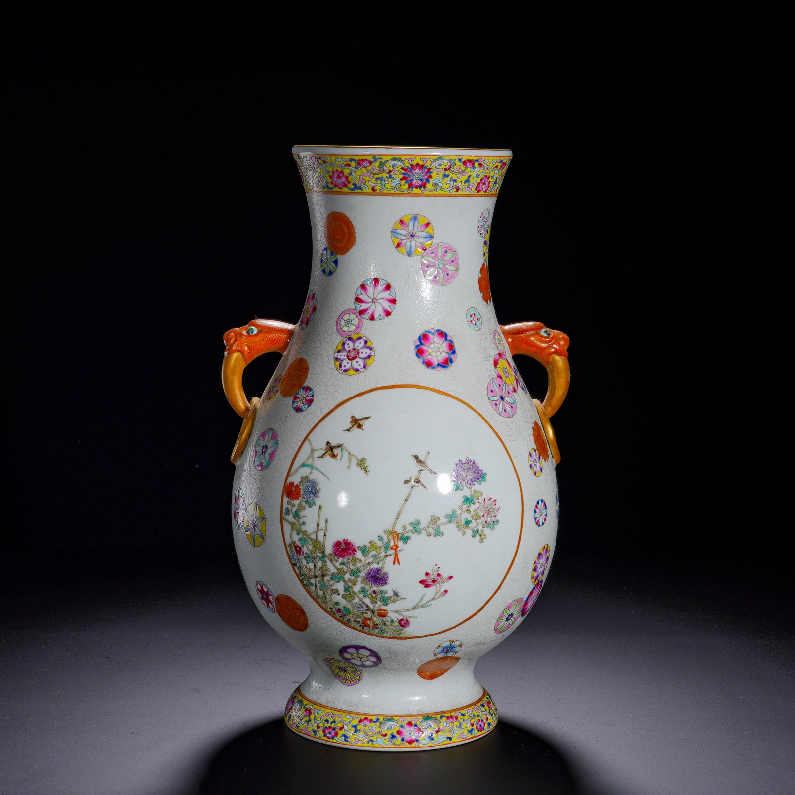 QING DYNASTY QIANLONG PASTEL PATTERNED BALL FLOWER AND BIRD PATTERN ELEPHANT-EAR VASE: Height:31cm (12.20in) , Diameter:18cm (7.09in) A magnificent imperial famille?rose display vase of Qianlong reign. Fitted with gilded elephant?head ring handles symbolizing peace and prosperity. The w