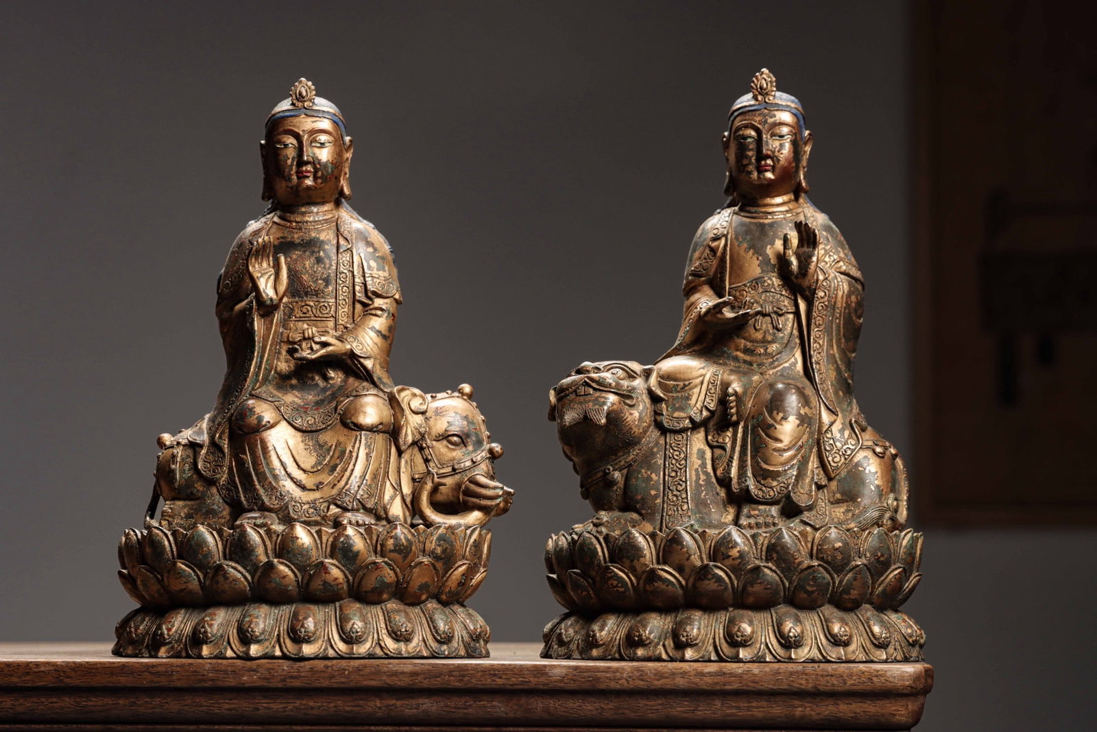 GILDED BRONZE STATUES OF MANJUSRI AND SAMANTABHADRA FROM THE QING DYNASTY: Weight:6750g (14.881lb) Height:18cm (7.09in) Width:17.5cm (6.89in) Thick:23cm (9.06in) Pair of lacquered-gilded statues of Manjushri and Samantabhadra. Manjushri rides a green lion representing wisdom