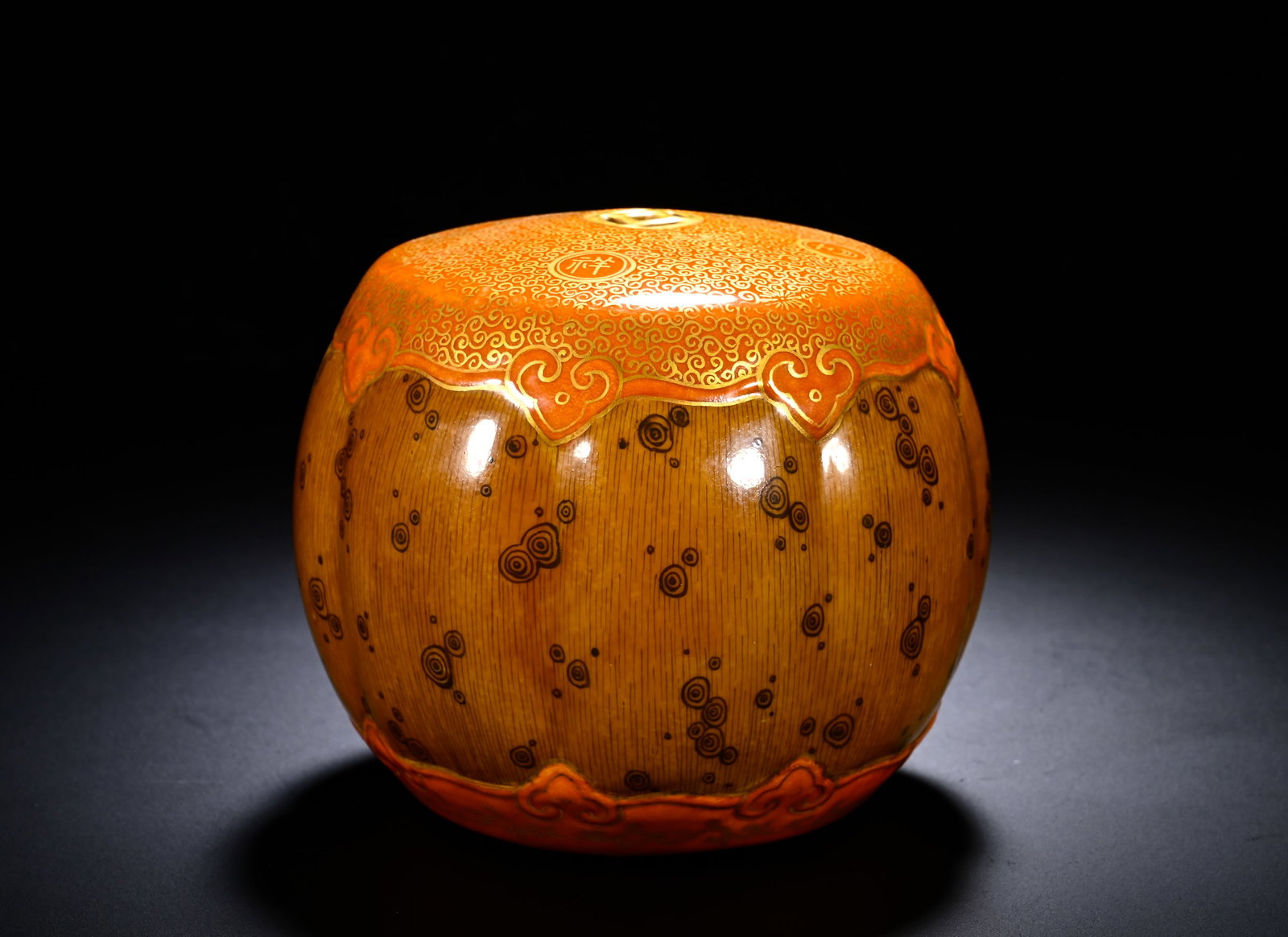 QING YONGZHENG GLAZED GILDED RUYI CLOUD PATTERNED GOURD-SHAPED JAR: Height:11cm (4.33in) , Diameter:11cm (4.33in) Melon?ribbed form with stout rounded body and small circular aperture at top. The main body is covered in wood?imitative glaze simulating natural wood gra