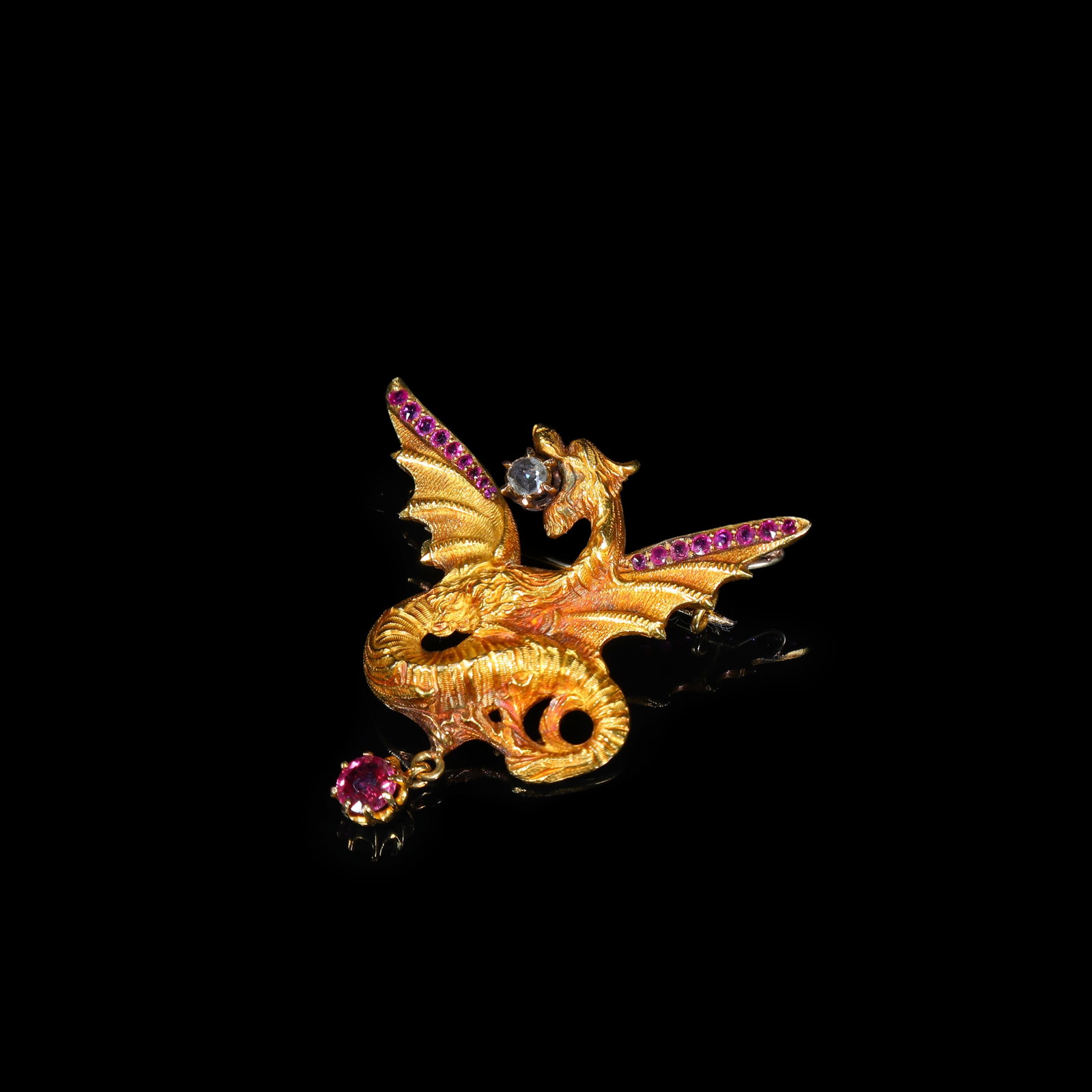 French Art-Nouveau 18K Gold Chimera Brooch, set with Diamonds and Rubies: 4.5*4.2cm Wt:12.8g French antique jewel dating to the Art-Nouveau period, circa 1890-1905, crafted in 18-carat gold. Modelled as a dynamically coiled high-relief Chimera mythical beast, with finely