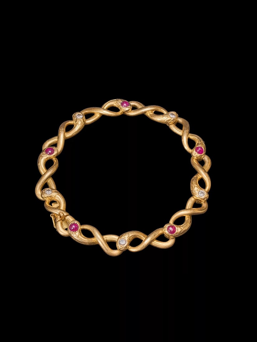 Late-19th-Century French Victorian-Period 18K Ruby and Diamond Ouroboros Snake Bangle: Bracelet Length:18cmWt:29.1g The coiled Ouroboros, the serpent biting its own tail with head and tail joined, symbolises "eternal love". This was a favoured jewel of Queen Victoria of Britain. The pin