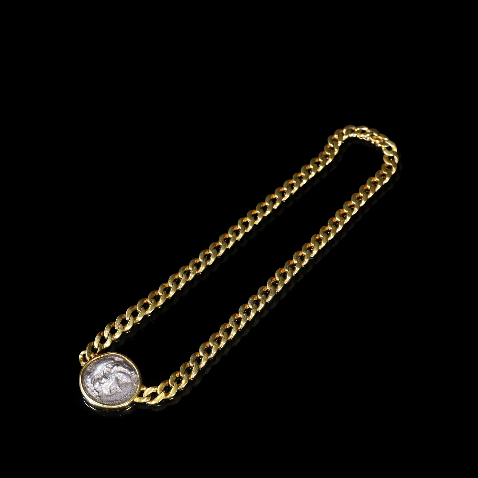 18-Karat-Gold Cuban-Link Necklace with Bezel-Set Ancient Silver Coin Pendant of Alexander the Great: Chain Length:19.5cm 2.45*3.6cm Wt:65.29g 18-karat-gold necklace of substantial cuban-link design. The pendant features an ancient silver coin of Alexander the Great securely bezel-set within a plain c