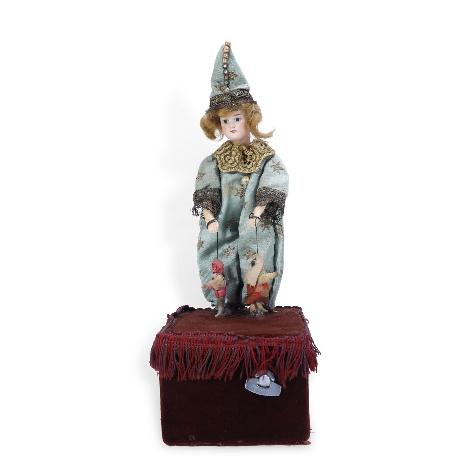 19th Century Music Box with String Puppet Performer Figure: H:29.5cm W:11cm Once wound up and activated, the piece plays music accompanied by synchronized mechanical movements of the figure:Its head turns left and right, and its arms rise and fall gently. Thin