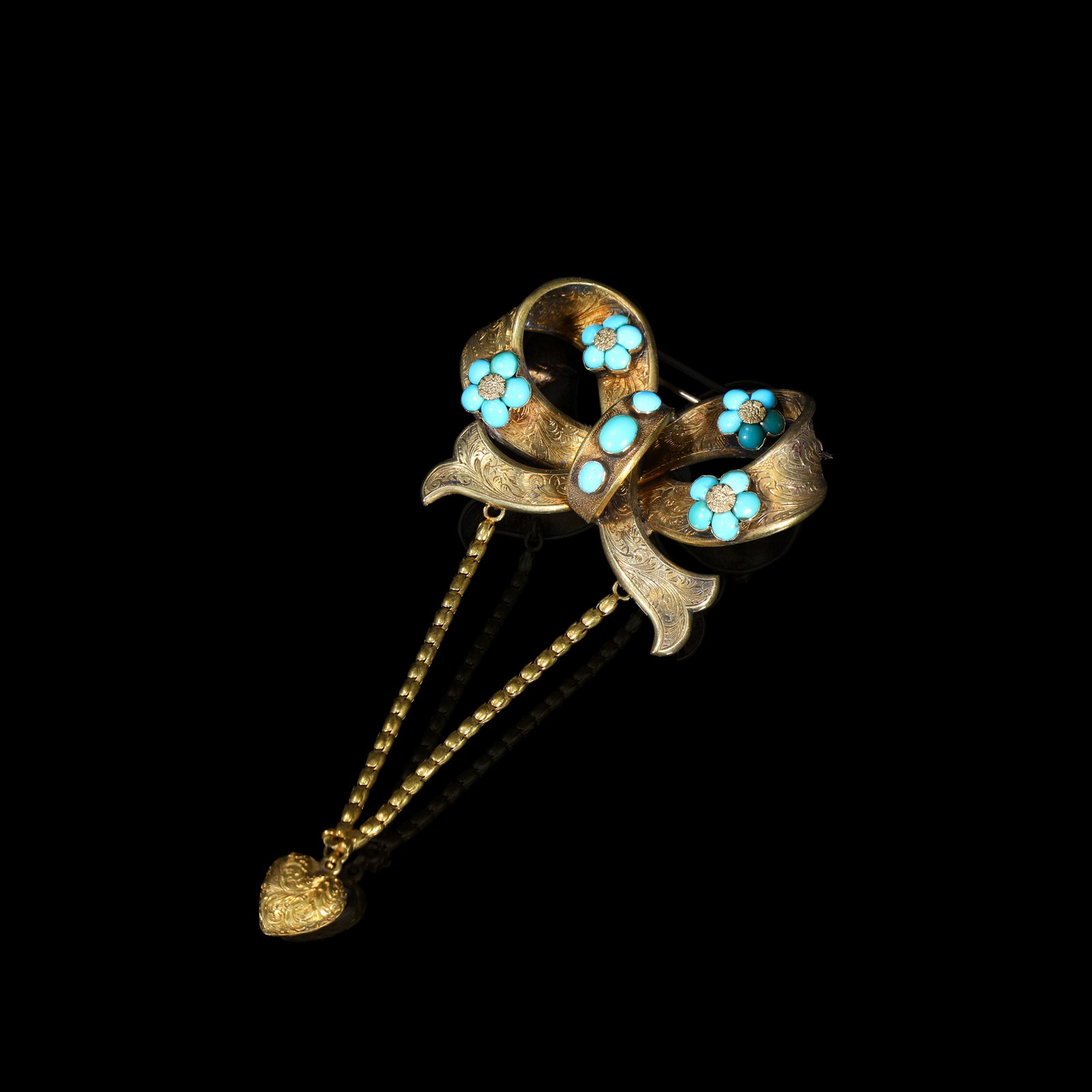 Victorian Engraved-22K Gold Turquoise Bow Brooch, Complete With Original Safety-Chain & Heart-Shaped: 3.8*5cm Total length 8-cm Wt:12.68g Victorian bow-form brooch, circa 1850-1870, a complete single original piece. Executed in engraved gold chased with scrolling foliate patterns, set with turquoise f
