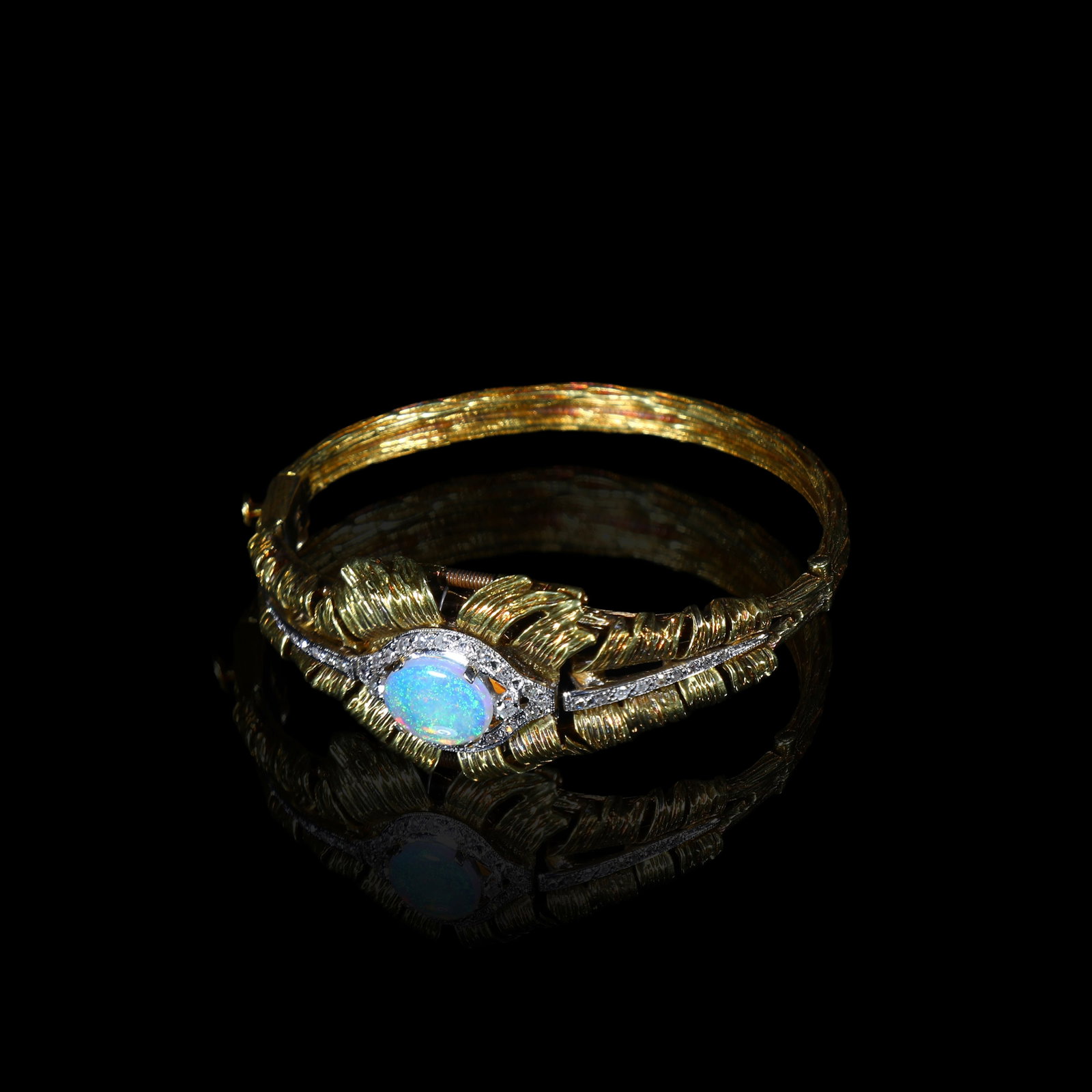 Victorian 18K/14K Gold Hidden Diamond Watch set with Natural Opal: Inner Length:16cm Maximum Width:2.2cm Dial Diameter1cm Wt:41.8g Movement: ALECTO, Swiss.Metal: Laminated 18K/14K gold.Set with one opal, 8.7mm x 11mm, accented with approx. 0.7ct of diamonds.