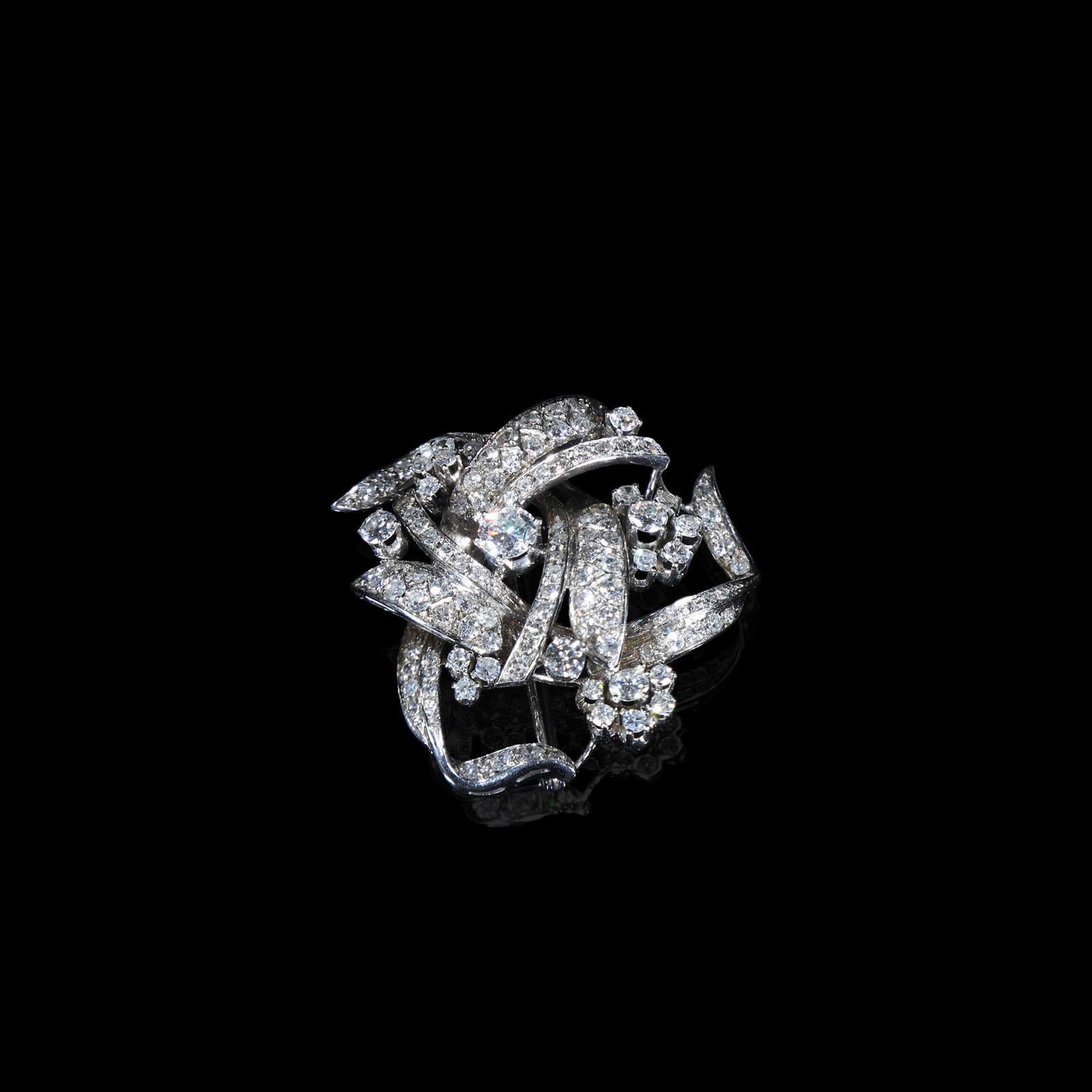 Edwardian-Period Platinum Diamond Foliate-and-Floral Brooch, Circa 1900-1915: 3.7*3.76cm Wt:15.43g Edwardian-period (circa 1900-1915) platinum diamond brooch. Designed in naturalistic foliate-and-floral motif with interlaced scrolling branches and clustered flower-heads. The mo