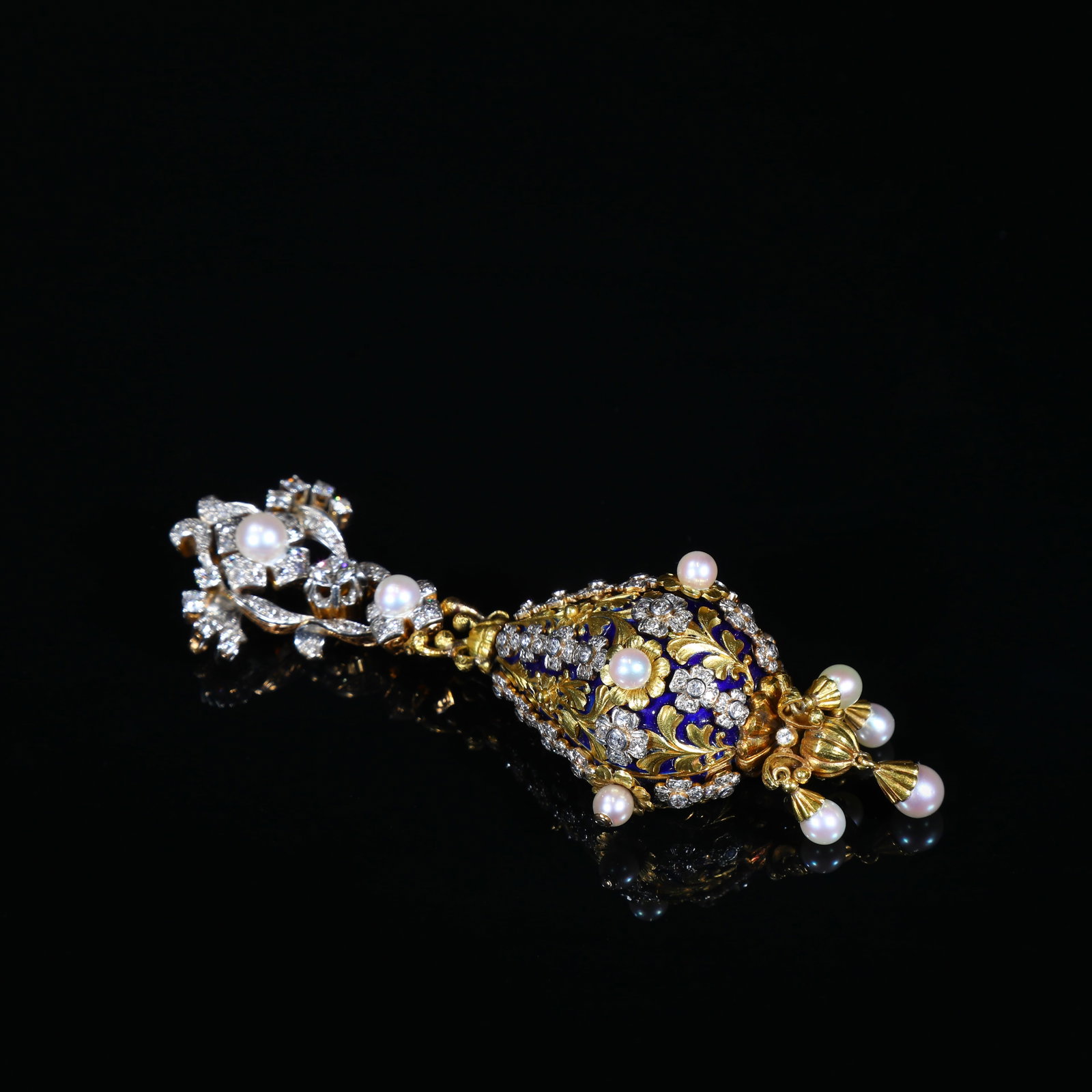 Edwardian-Period (Circa 1900-1910) Omega, Solid-Gold, Blue-Enamel, Diamond & Pearl Pendant-Watch: 10.9*3.8cm Wt:80.1g Edwardian-Period (Circa 1900-1910) Omega pendant-watch with solid-gold open-work basket-form case, enriched by deep translucent blue enamel and finely chased foliate-floral ornamen