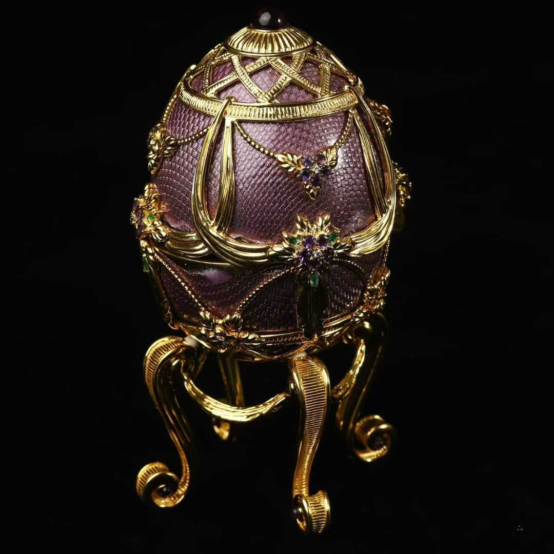 Faberg?? Easter Egg, Silver-Gilt Guilloch?? Enamel Gem-Set: Overall Height:14cm Height (without base):10.5cm D:7.5cm Wt:522g Entirely hand-crafted in sterling 925 silver, with hand-engraved guilloch?? overlaid with high-fired mineral enamel, accented with amet