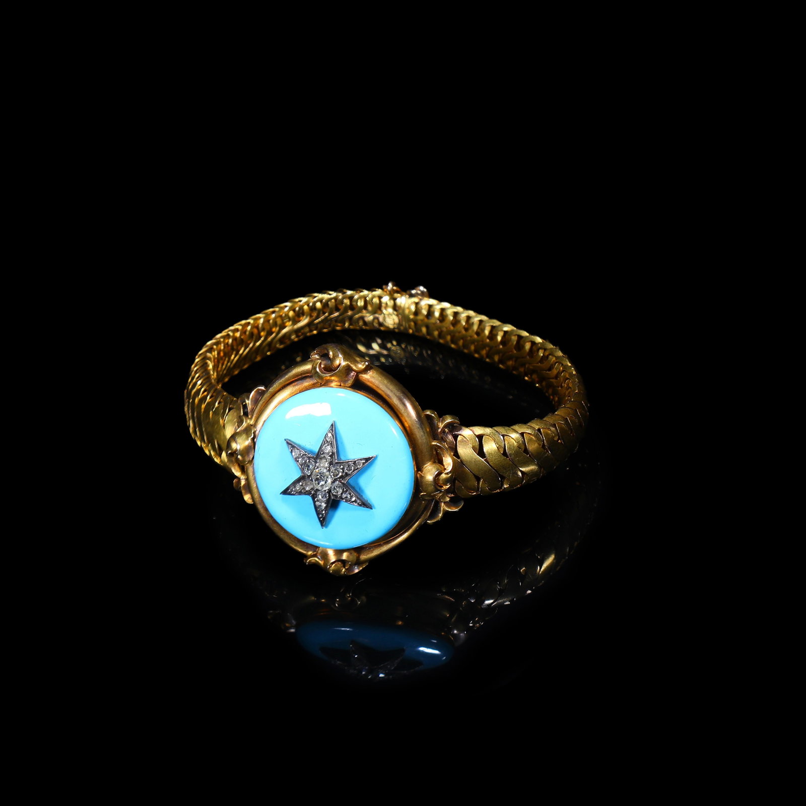 Victorian 14K Gold Blue Enamel Starburst Bracelet: Inner Length:18.3cm Maximum Width:3.6cm Wt:42.23g A quintessential Victorian bracelet with blue enamel starburst motifs, entirely woven in an intricate, substantial construction. Centred by a diamond-