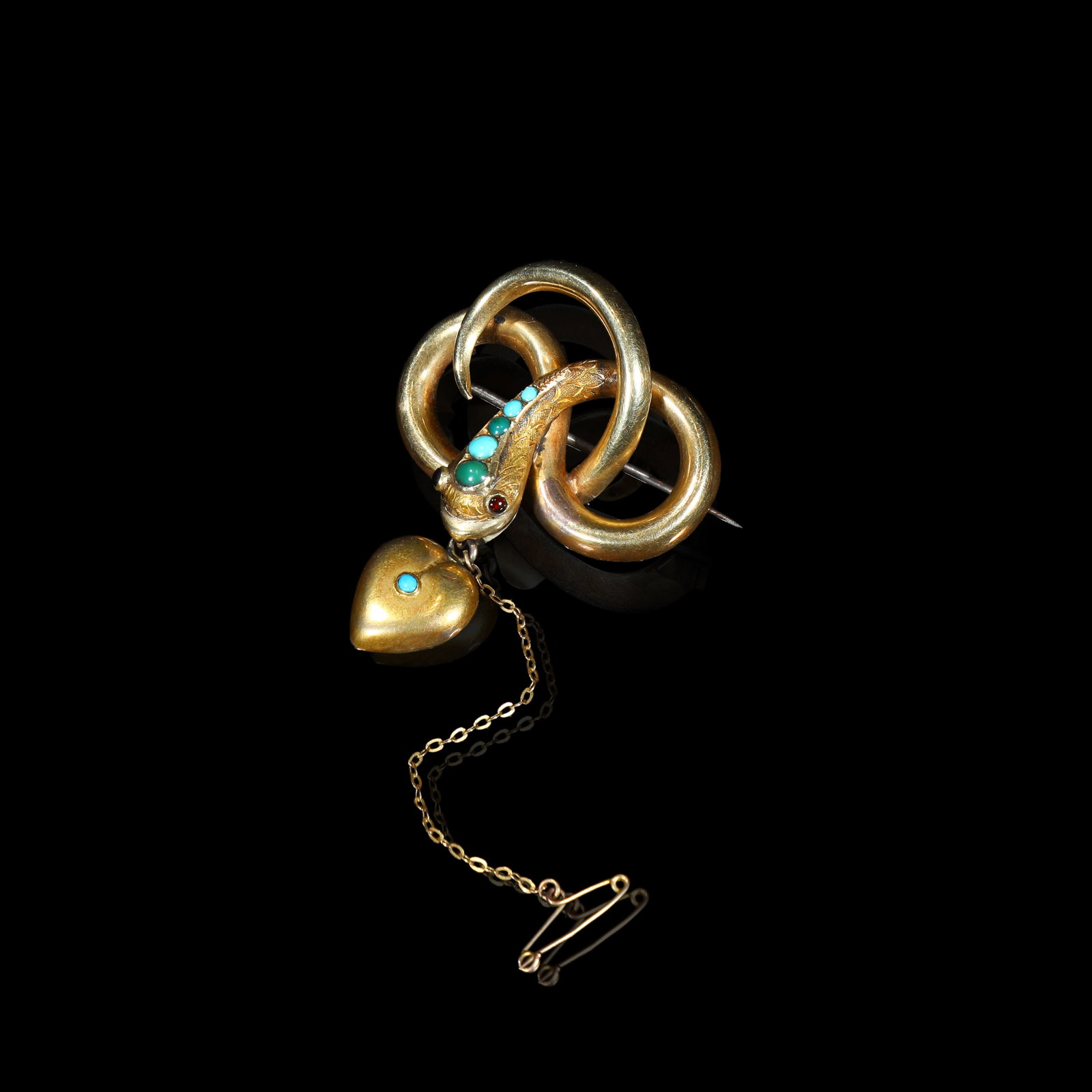 Victorian Gold Serpent Brooch, Turquoise, Ruby with Turquoise-Set Heart Drop: 4.6*3.85cm Wt:7.34g Victorian-era gold serpent brooch. Modelled as triple interlocked coiled loops with hand-brushed textured gold finish. Serpent eyes set with rubies; its neck decorated with turquoi