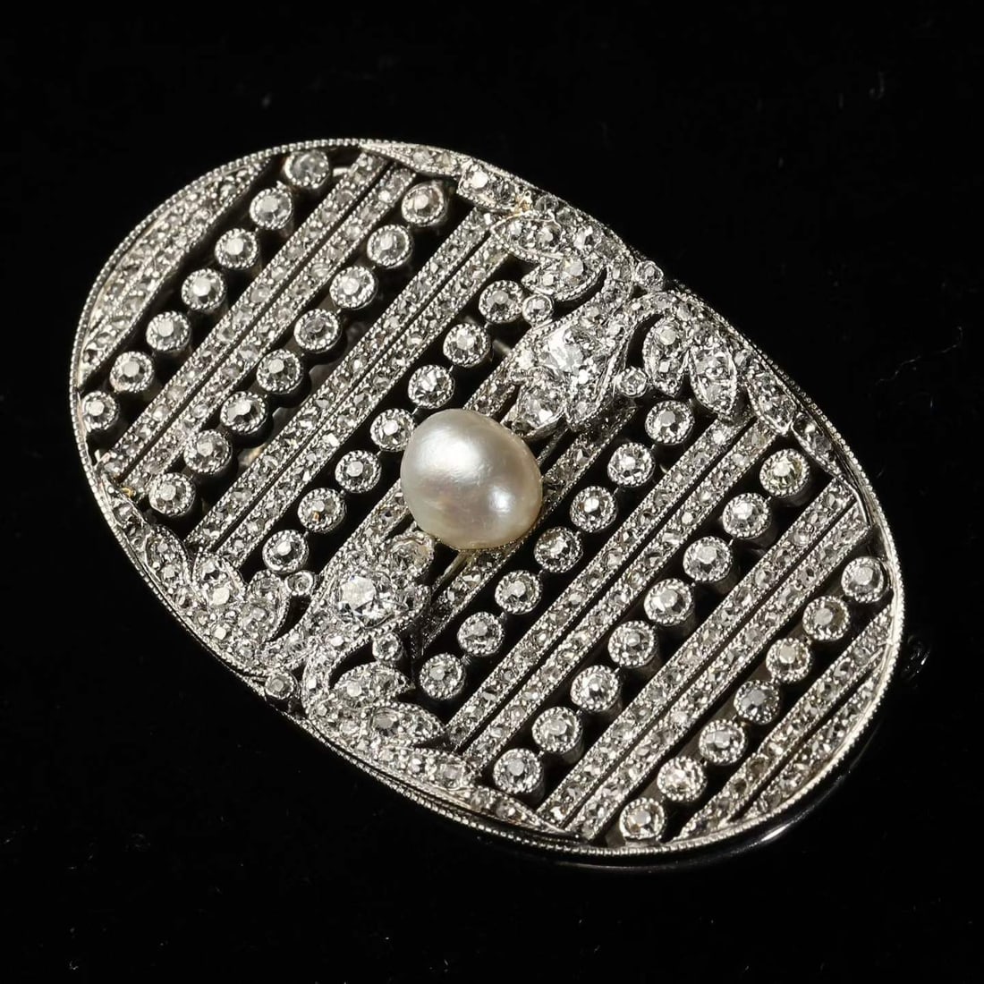 Art Deco Period (1925-1935) French Aristocrat Custom Platinum Diamond and Natural Pearl: L:4.0cm W:2.5cm Wt:16.9g This brooch revives the modern glamour of the Art Deco era through sharply geometric, symmetrical lines and luxurious materials, capturing the rhythm of the Machine Age and th