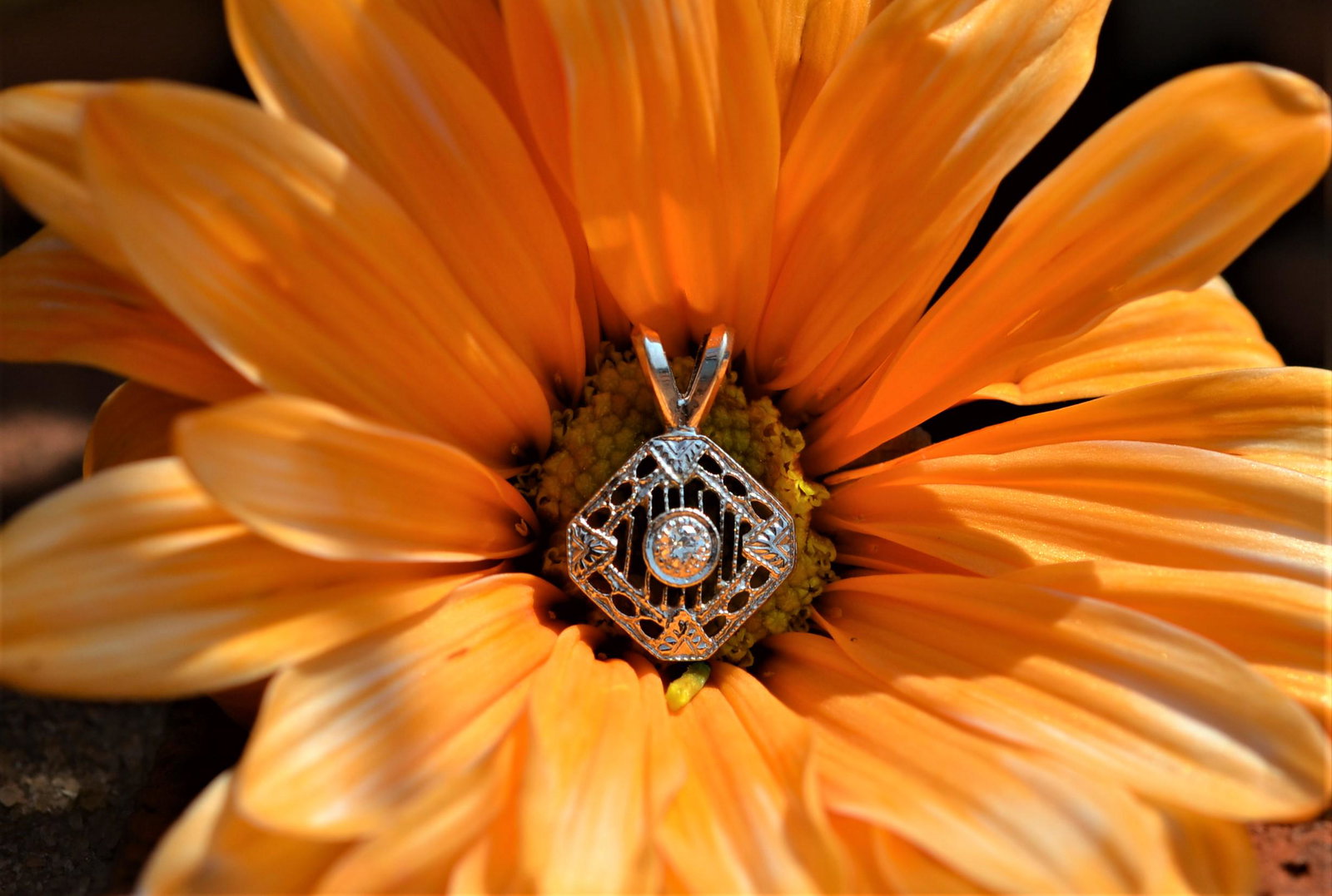 Custom Antique Filagree Diamond Pendant: This custom, white gold antique diamond pendant appears as though the top of an antique engagement ring was soldered on a split bale to wear as a pendant. This octagonal pendant has an oval and bar fi