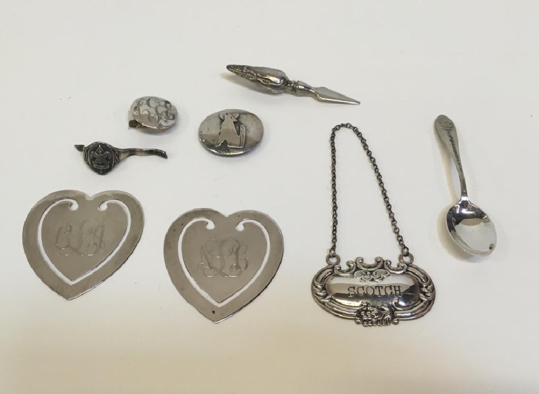 8 PCS OF STERLING & SILVER PLATE: Sterling includes - broken "Be Prepared" ring, corn skewer (cob only), Scotch decanter label, wolf pendant, sweater clip (monogram), 1953 Wash. DC souvenir spoon - combined weight 46g. Silver plate in
