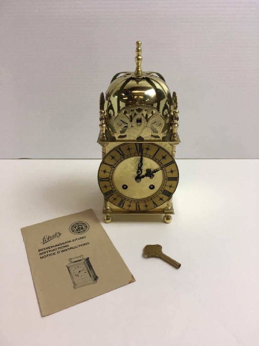 VINTAGE AUG. SCHATZ & SOHNE MANTLE CLOCK: Key wind brass lantern clock, 9.25" h, 7 jewels, case make in Great Britain, working condition w/ key & instructions.