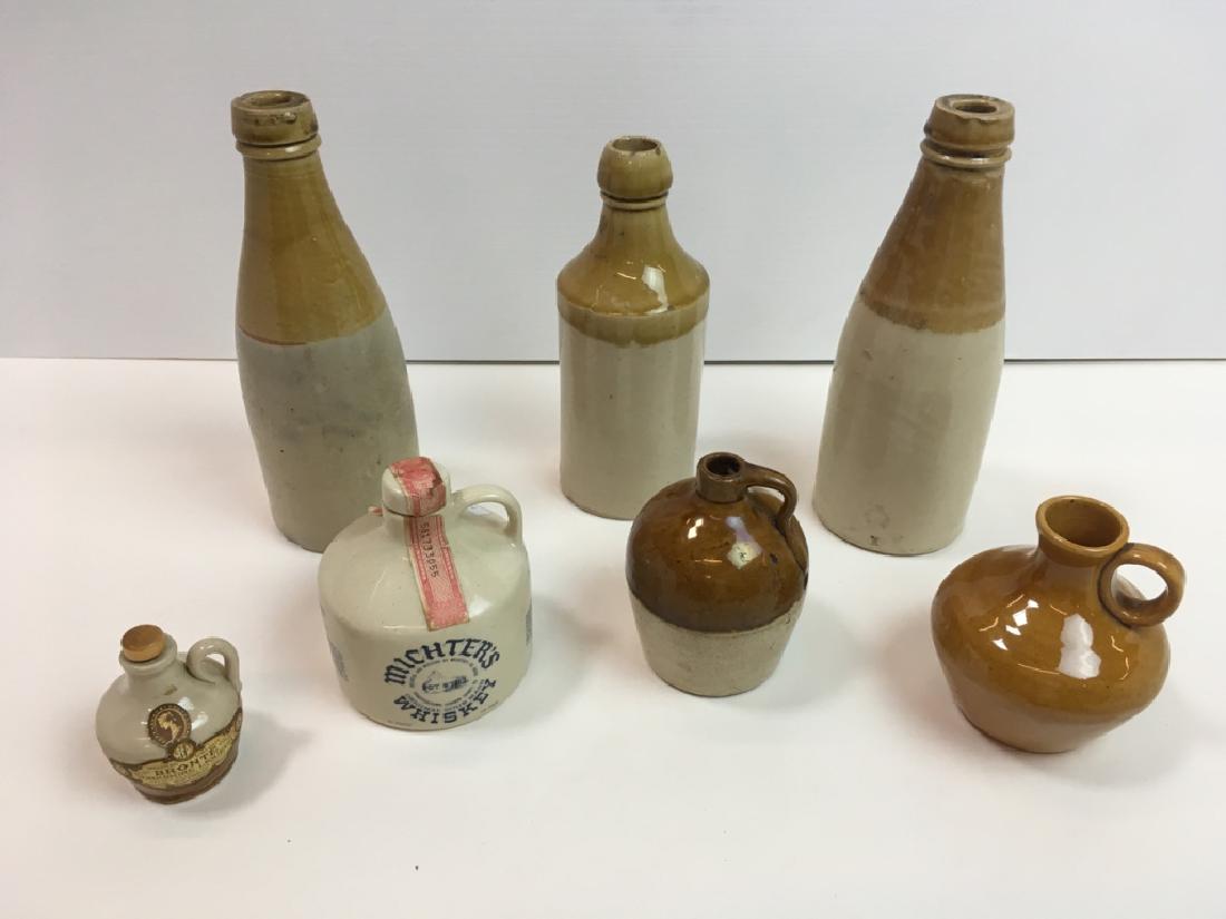 7 STONEWARE BOTTLES & JUGS: 2 antique 8.5" h bottles both marked, 7.5" antique bottle (base & rim chips), 2 glazed jugs 4" h, Michter's Whiskey 4" h jug & Bronte Yorkshire Liqueur 2.75" h jug.