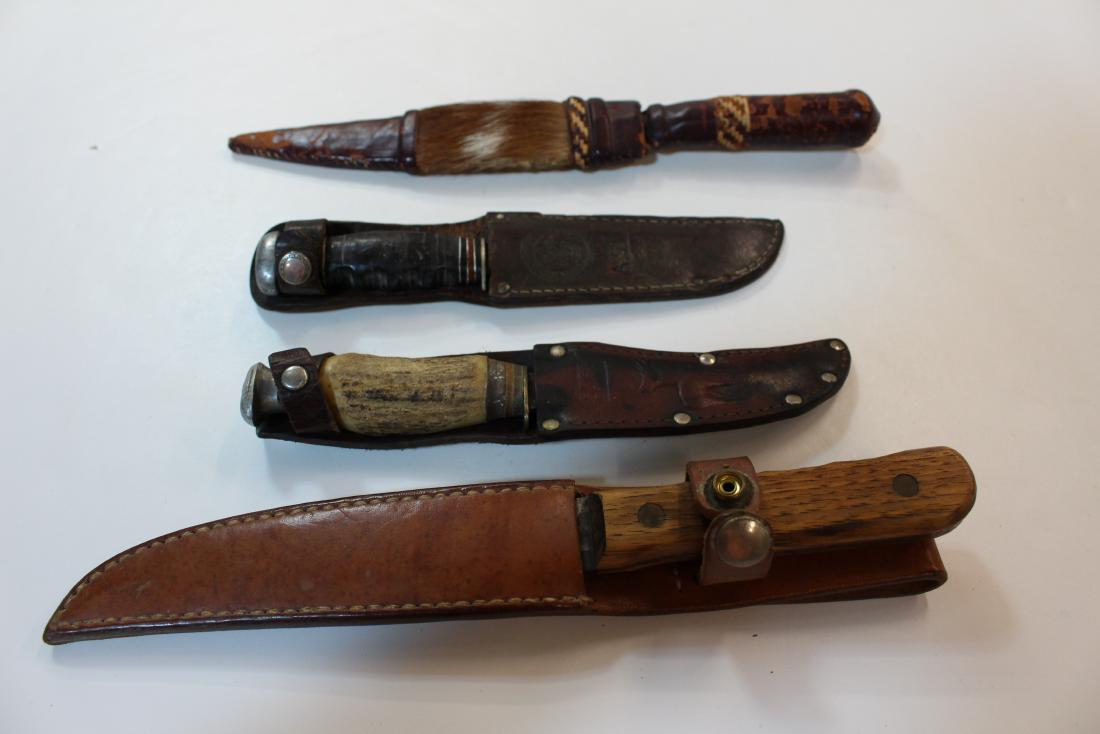 FOUR VINTAGE KNIVES AND SHEATHS: Includes a Remington knife in a Boy Scout sheath - Bone handled hunting knife - Old Hickory in an added sheath - Hand made knife and sheath with fur accent on the sheath.