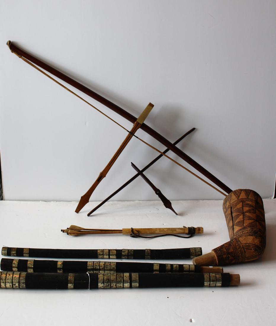 GROUP OF TRIBAL PIECES: Includes a large ceremonial pipe attributed to Vietnam from 1969 - Cross bows and arrows.