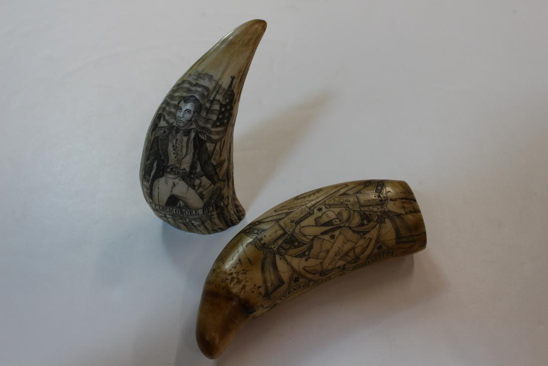 PAIR OF COMPOSITE SCRIMSHAW WHALE TEETH: Item 1. Illustrated with a highly image of Commodore Perry - 5.75 x 3 - Item 2. Illustrated on both sides with Western image of a stage coach on one side and a montage of pistols, boots and flags. Tur