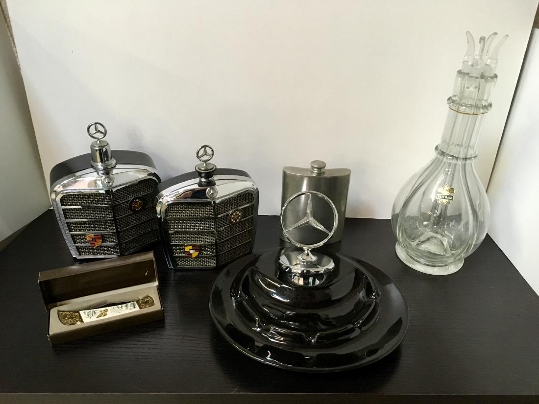 SIX PCS - DECANTERS, ASHTRAY, RADIO AND KNIFE: Includes a vintage 1968 Royal London Mercedes-Benz grill music box plastic decanter playing "How Dry I Am" in working condition 8" h, Mercedes-Benz grill 6 transistor AM radio Japan #803 plays static 