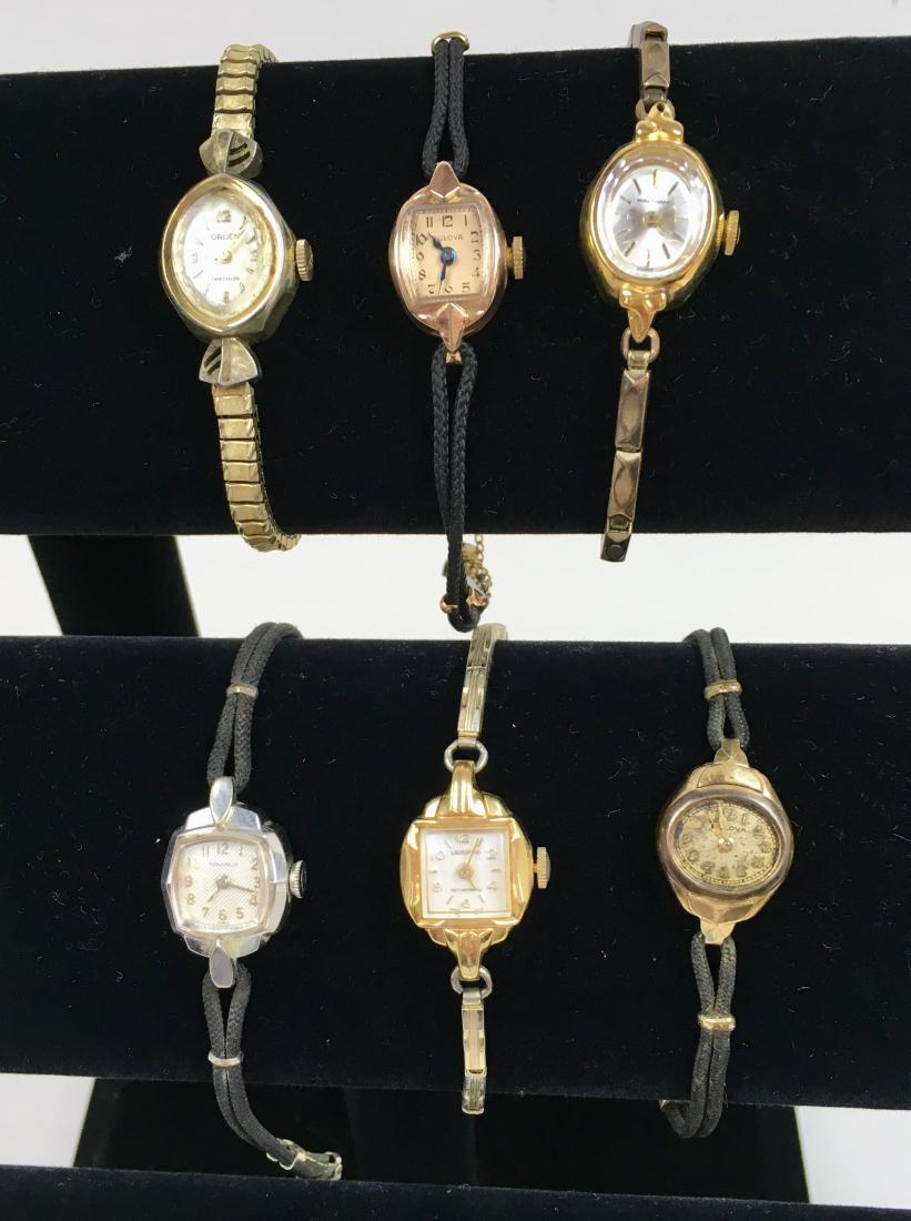 SIX VINTAGE LADIES' WRIST WATCHES: Bulova 14k gold filled G013293 in working condition, Gruen Precision Swiss non-working, Lausanne Anti Magnetic Swiss non-working, Waltham Swiss non-working, Caravelle Swiss non-working and a Bulova no
