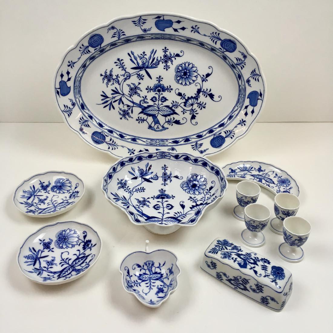 ELEVEN PCS OF BLUE ONION CHINA: Blue Onion pattern china with various Meissen crossed swords markings on ten of the pcs - includes 18.5" oval platter, 10" shell bowl, two 5.5" dishes, 5" long leaf bowl, 7" long bone dish, four 2.75"