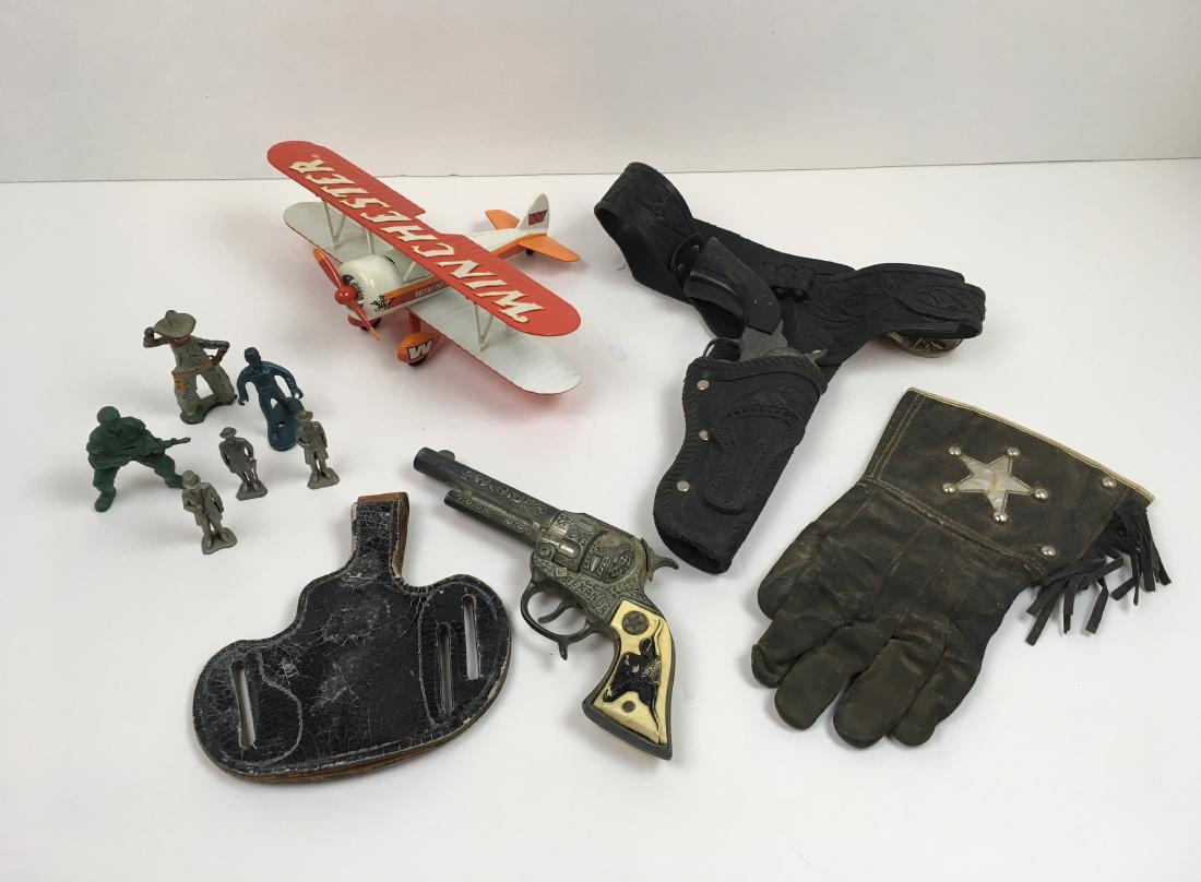 12 PCS - VINTAGE TOY GUNS, WINCHESTER PLANE & MEN: Includes vintage toy holster with Pony Boy cap gun, vintage Texan Jr cap gun, toy sheriff's glove, Roy's Leather Goods Pancake gun holster, Winchester advertising Bi Wing metal plane ltd. Edition #514
