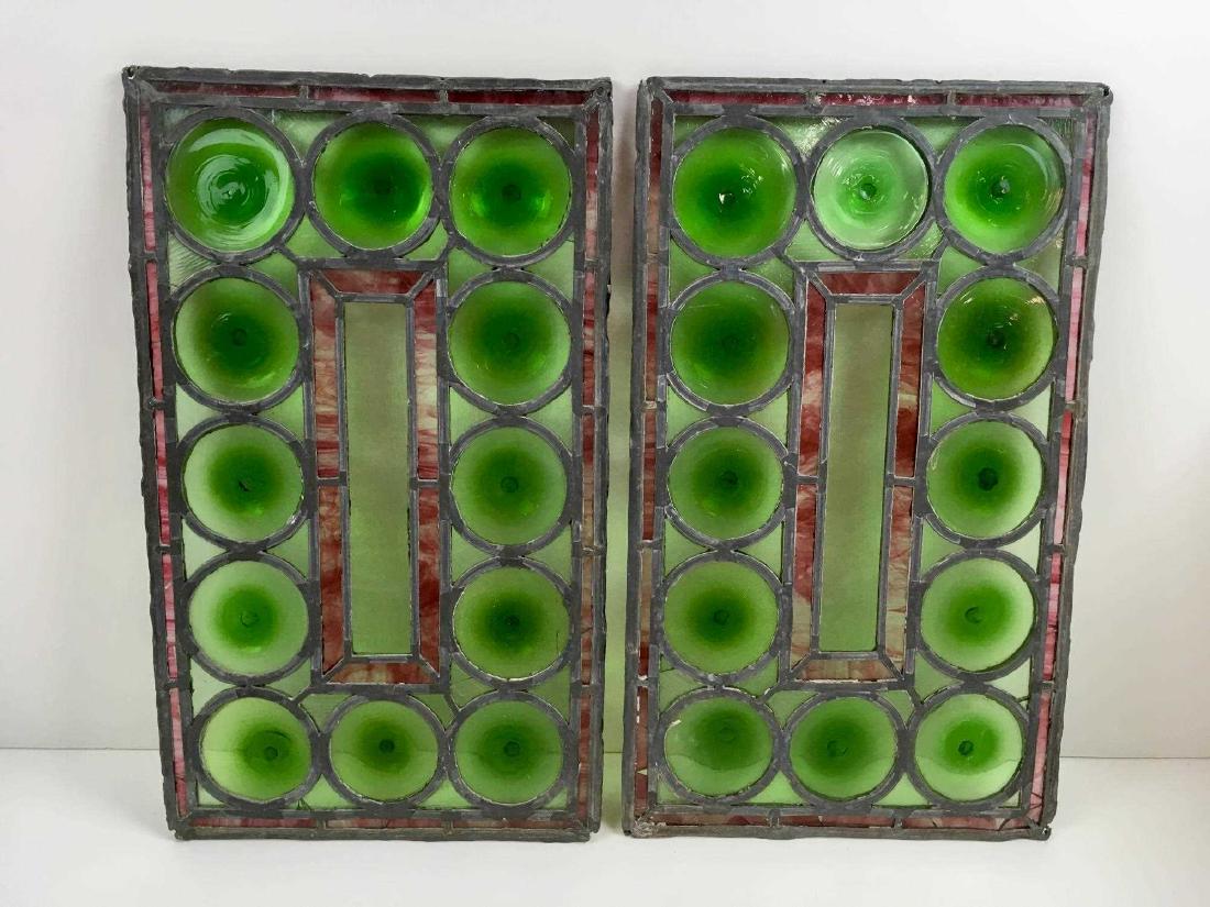 TWO ANTIQUE LEADED STAIN GLASS WINDOWS: Green blown glass rounds with rose colored slag glass inserts 11.25" l x 18.25" h - leading is fragile in certain areas - several areas of small missing glass and cracks - please see photos for issues