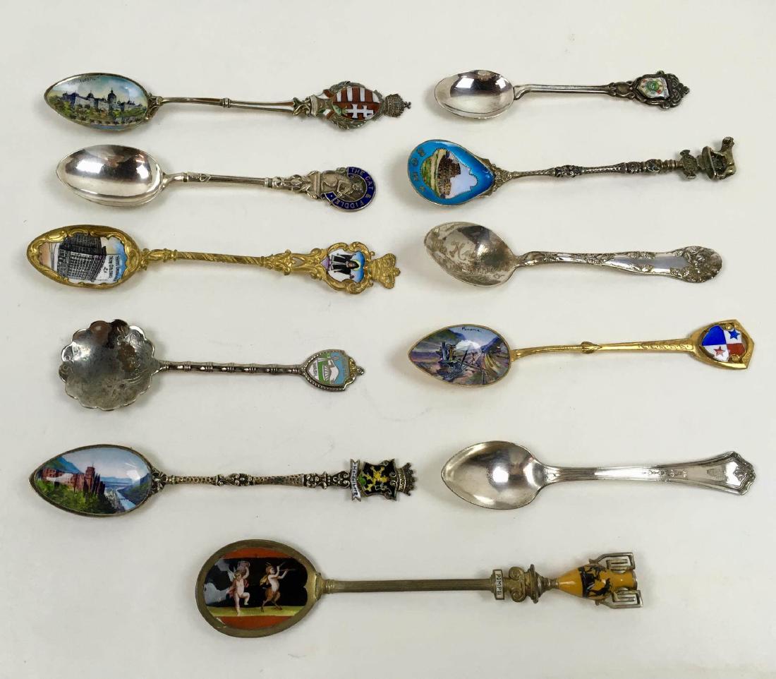 ELEVEN SOUVENIR SPOONS: 11 vintage souvenir spoons some with enamelwork - includes Swiss, the Cat and the Fiddle, New Orleans, Mount Washington, Heidelberg, Pompeii, Panama, Harlem, Roma, and the Mayflower Hotel
