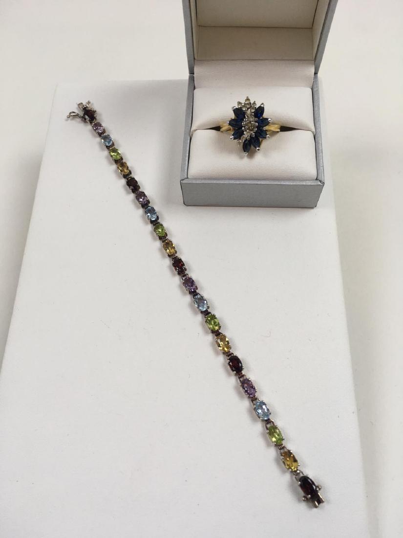 TWO PCS OF JEWELRY - BRACELET AND RING: Tennis style bracelet with 21 gemstones set in 925 / sterling 6.5 inches weighing 8 g plus an 18k heavy electroplated faux sapphire and faux diamond ring size 10